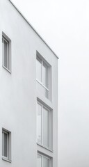 Obraz premium Minimalist white apartment building exterior, angled view