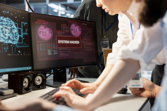 Close up of engineering team reviewing AI systems warnings after detecting irregular network activity patterns. Teamworking colleagues evaluating threats using artificial intelligence detection tools