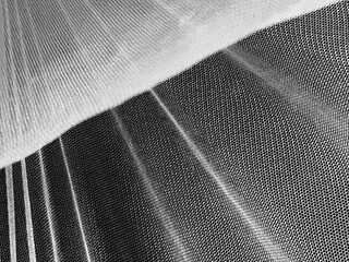an abstract background of a mosquito net, photograph taken from the inside.