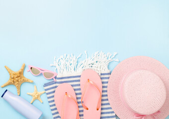Blue beach accessories on color background, top view. Copy space for text