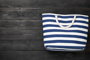 Blue beach bag on wooden background, top view