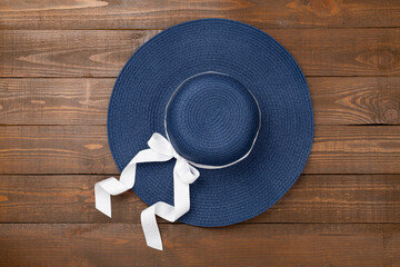Blue beach hat on wooden background,top view