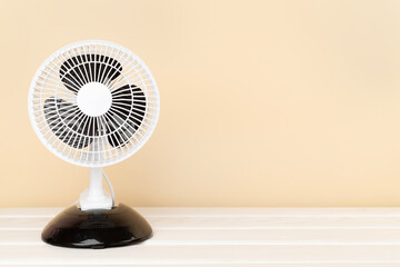 Electric fan on wooden background