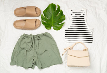 Flat lay with casual summer outfit on color background, top view