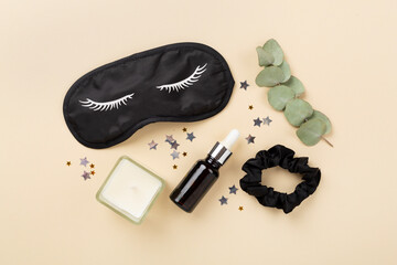 Sleeping mask with accessories on color background, top view. Sleeping routine concept
