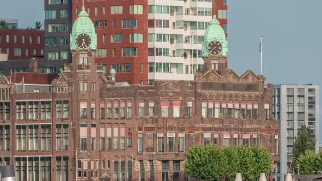 Timelapse of Hotel New York's historical facade in downtown Rotterdam. Former Holland-America Line HQ. People relax on the waterfront as boats pass by. Iconic architecture near the harbor