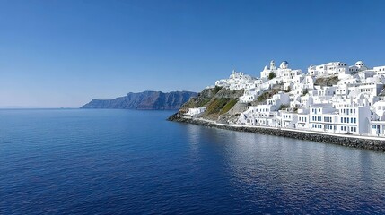 Panoramic view of a picturesque white village nestled on a hillside overlooking the ocean.