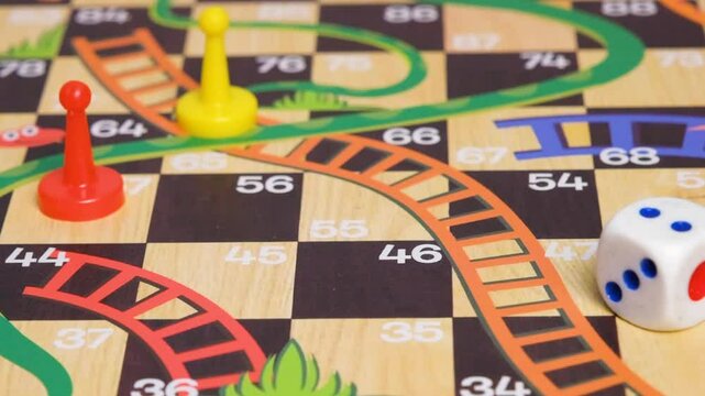 Slow motion video of a hand rolling a dice on a board game. Board game with friends concept