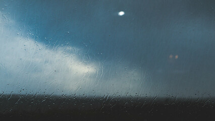 Raindrops on a window glass mood stormy dark
