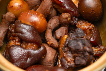 angle view pot of pork knuckles and ginger stew with eggs