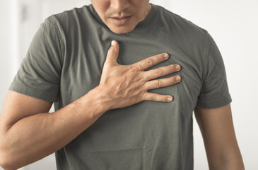 young man feeling ill with cough chest pain 