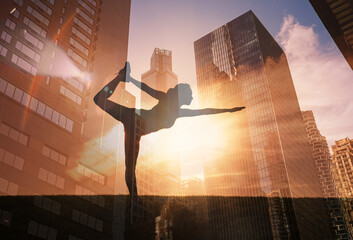 Silhouette of woman doing yoga stretching exercise outdoors against city sunset. body health balance concept 