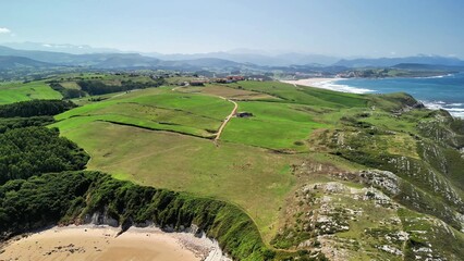 Explore the stunning coastal landscape with lush fields and a beautiful beach view