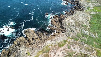 Experience the magnificent scenic coastal views featuring waves crashing against a rocky shoreline