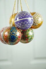 Hand-painted papier-mâché Christmas balls designed for hanging on Christmas trees, combining traditional craftsmanship with festive charm for seasonal decoration.

