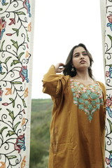 Kashmiri girl posing wearing pheran and shawl