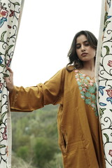 Kashmiri girl posing wearing pheran and shawl