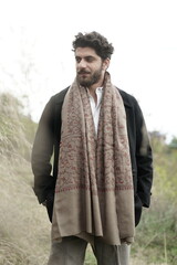 A Kashmiri model dressed in a traditional shawl and vintage-style pheran, posing for a Kaar Kash...