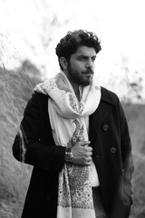 A Kashmiri model dressed in a traditional shawl and vintage-style pheran, posing for a Kaar Kash shoot that highlights timeless craftsmanship and the cultural soul of Kashmir.

