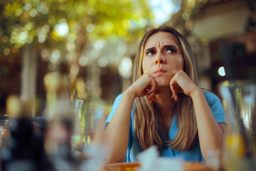 Woman Overthinking her Problems Sitting in a restaurant. Frustrated person feeling overwhelmed with negative thoughts 
