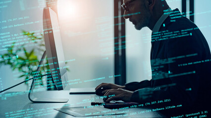 Conceptual visual of a man working in an office with programming code