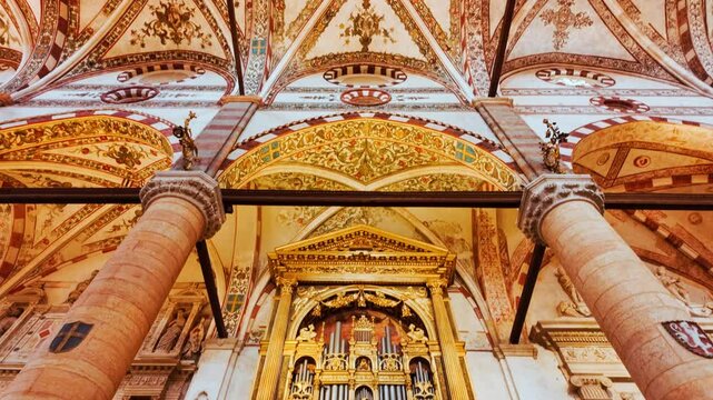 Interior of Basilica di San Zeno Maggiore displays its expansive nave flanked by pilasters and lined with historic fresco fragments, Verona, Veneto, Italy