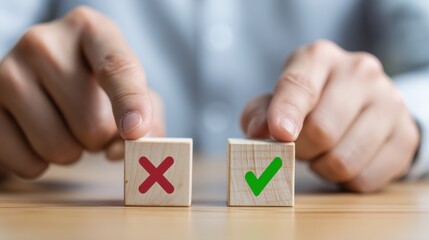 close-up of human hand pointing at two wooden cubes on a desk, one with a red X and the other with a green checkmark, blurred person in business shirt in background