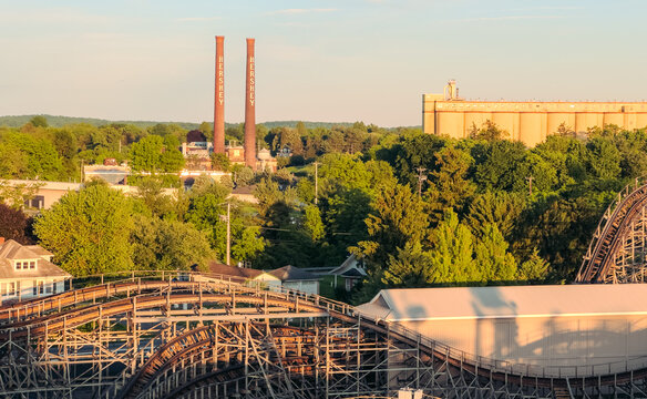 Hershey, PA . USA - May 26 2025: View of iconic Hershey smoke stacks and roller coasters, from the ferris wheel 