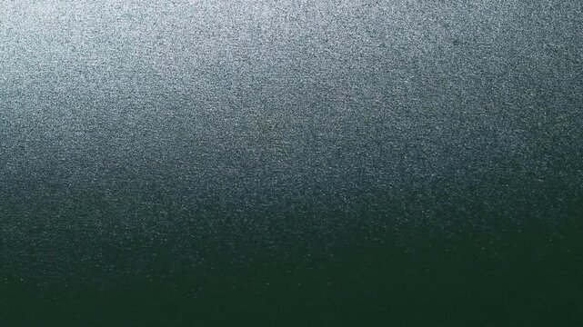 Close-up of colorful construction paper texture with soft, fluctuating shadows creating a subtle, dynamic background loop.