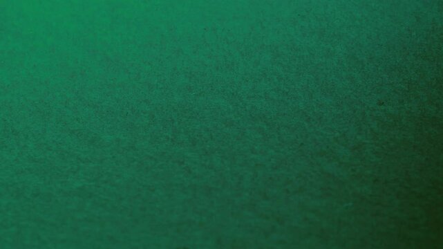 Close-up of colorful construction paper texture with soft, fluctuating shadows creating a subtle, dynamic background loop.
