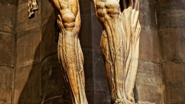 Close perspective on the marble statue of St Bartholomew flayed exposing fine anatomical detail within the Duomo di Milano, Milan, Lombardy, Italy