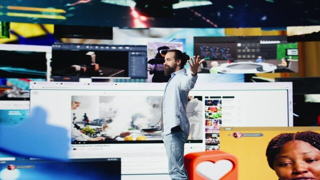 Young happy adult focused on online connection and scrolling on social pages, texting his friends and creating quality content for global reach. Trend setter guy on web design. Camera B.