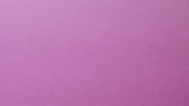 Close-up of colorful construction paper texture with soft, fluctuating shadows creating a subtle, dynamic background loop.