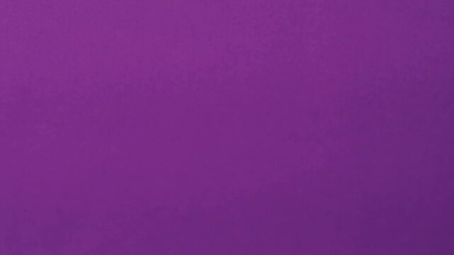 Close-up of colorful construction paper texture with soft, fluctuating shadows creating a subtle, dynamic background loop.