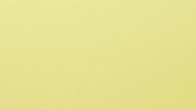 Close-up of colorful construction paper texture with soft, fluctuating shadows creating a subtle, dynamic background loop.