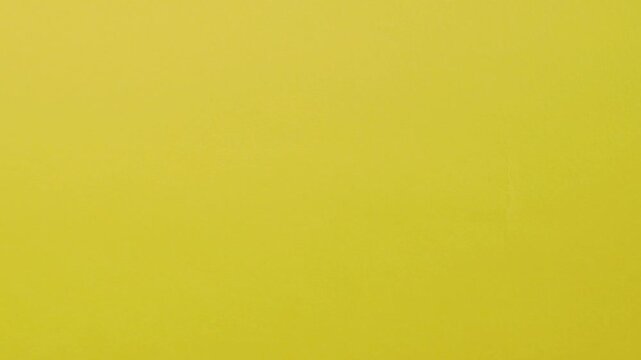 Close-up of colorful construction paper texture with soft, fluctuating shadows creating a subtle, dynamic background loop.