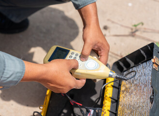 Environment officer setting sound level meter device.