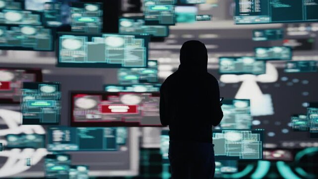 Male hacker breaking into a system in stealth mode by programming code, bypassing firewalls and exploiting vulnerabilities in network security to carry out cyber attack and infiltration. Camera B.