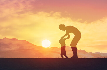 Silhouette of mother teaching toddler to walk, child  growth development, baby steps 
