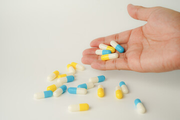 Male hand holding white capsule pill, isolate background, pharmacy, medicine, health care