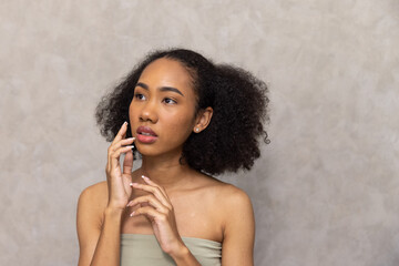 Happy Black Woman With Curly Hair against White Background, Portrait.