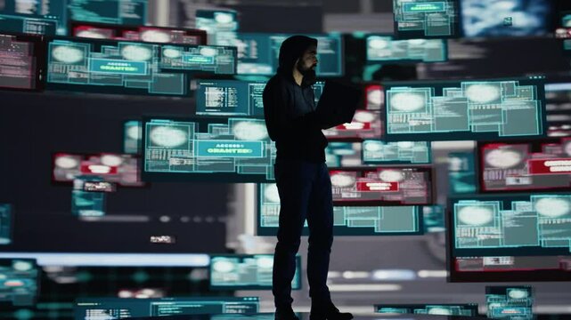 Conceptual representation of cyber crime with male hacker exploiting system vulnerability, using programming technique and surveillance to override digital defenses and leak information. Camera B.