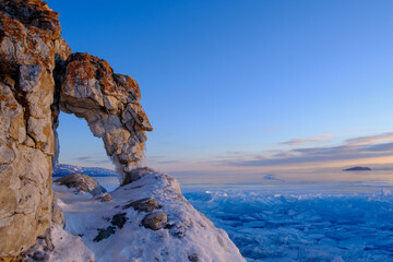Cape Kurma view above big beautiful frozen lake and mountain in winter, Baikal lake, Russia