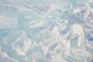 Endless hummock field on frozen Lake Baikal. Piles of snow-covered debris of blue ice on frosty day