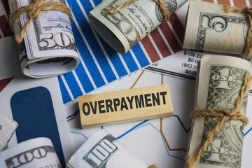 Concept of Overpayment. Wooden block with words overpayment