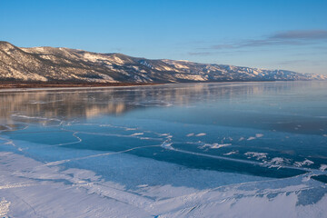 View above big beautiful frozen lake and mountain in winter, Baikal lake, Russia
