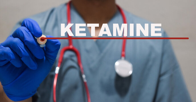 A doctor man holding pen with text ketamine