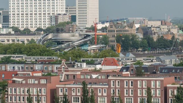 Panoramic aerial timelapse of Katendrecht peninsula and Maashaven harbour in Rotterdam, The Netherlands. City skyline at morning, modern towers, construction site and traditional waterfront houses