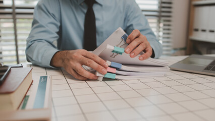 a businessman is handling documents in the office, an accountant is collecting documents, a...