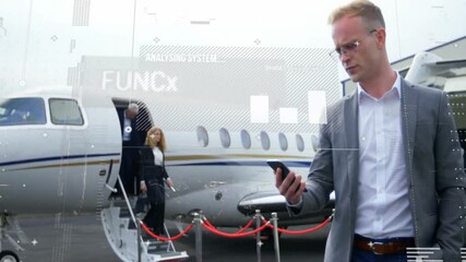 Male executive checking smartphone starting business overlay, team descending jet stairs red carpet - Powered by Adobe